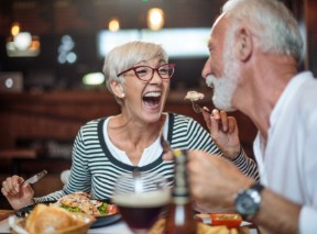 woman laughing & eating with her husband 5 reasons to self directed ira - BLOG